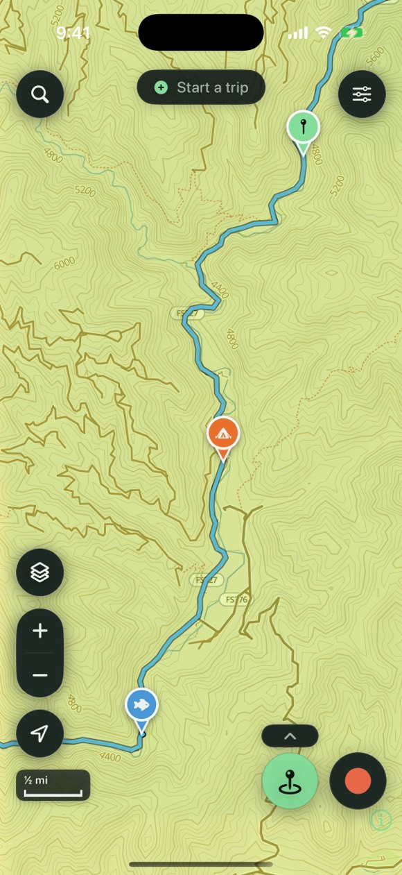 Trailmark ADV showing a recorded backcountry ride tracing a forest road on the on-device vector topo — with campsite and waypoint pins dropped along the track amid labelled contours and a dense trail network